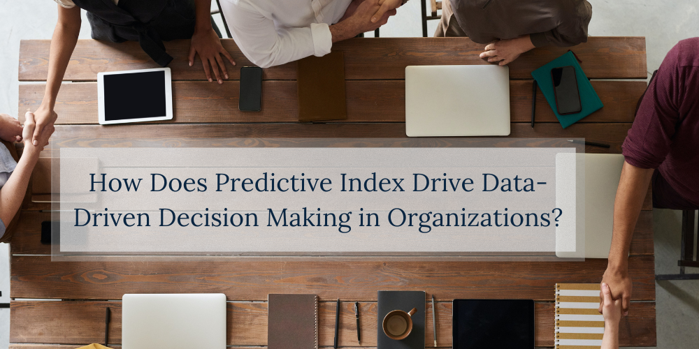 A team sits at an office desk and works on The Predictive Index