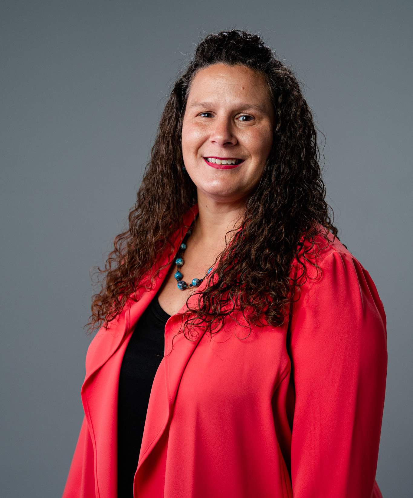 Rachel Digman employee of KF Strategies looks and smiles at the camera for a professional headshot photo