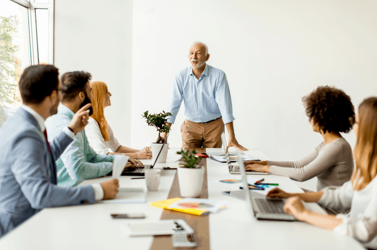 a few professional people sit at a round table to discuss how to be a better leader